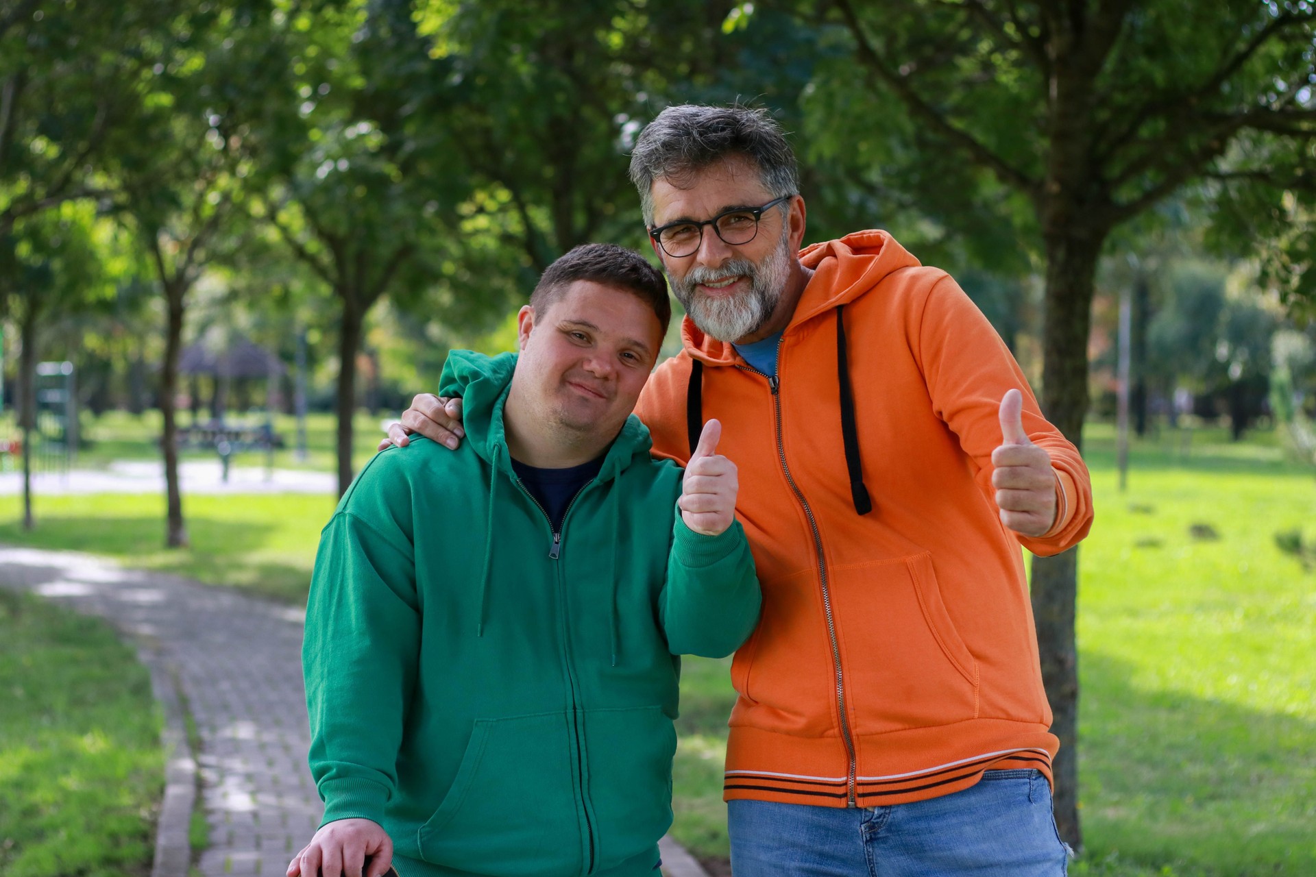 Young man with developmental disabilities enjoying time outdoors with his father—symbolizing family support, inclusive recreation, and positive relationships for adults with disabilities