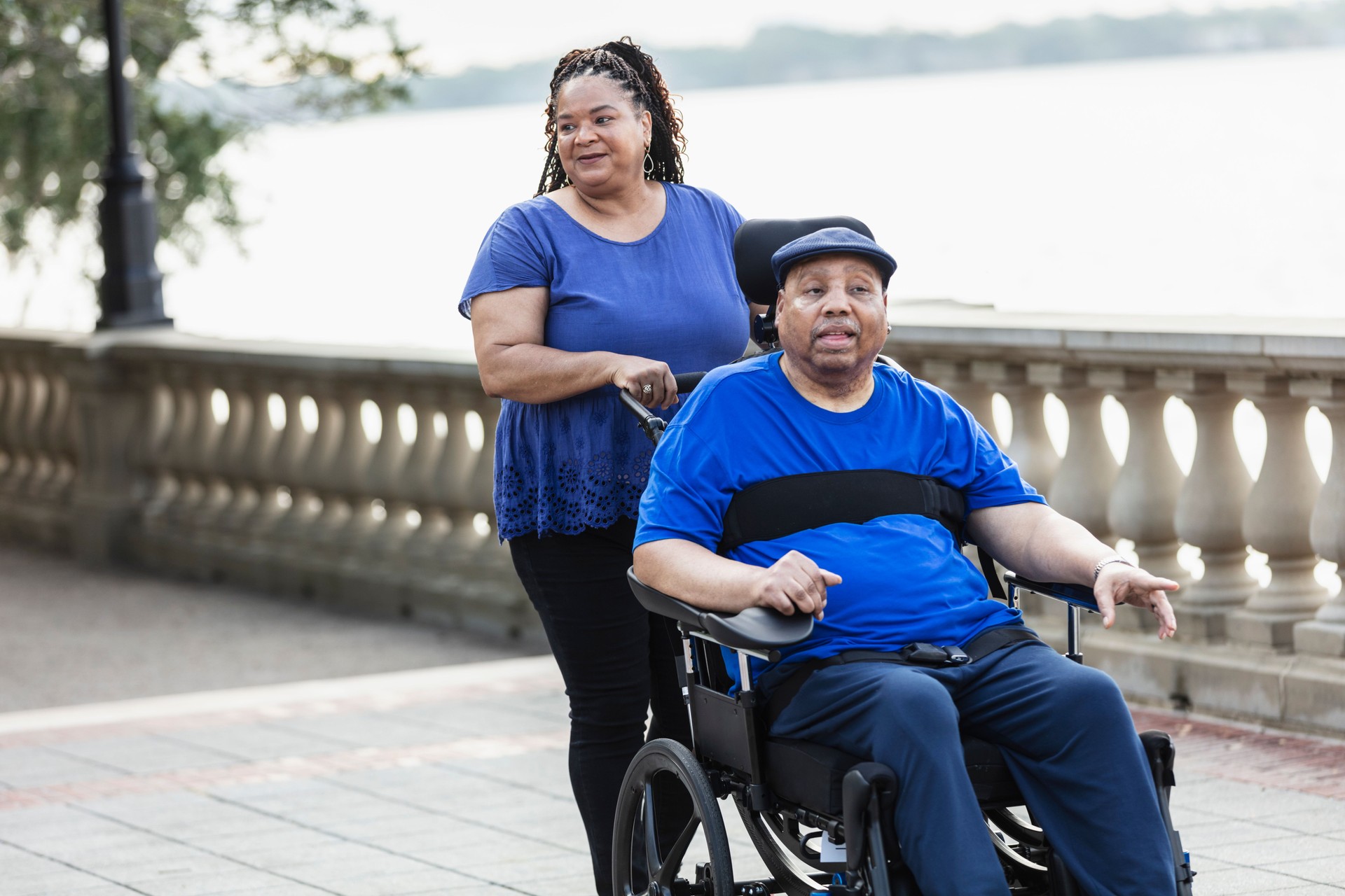 Senior African-American couple on walk, with wheelchair