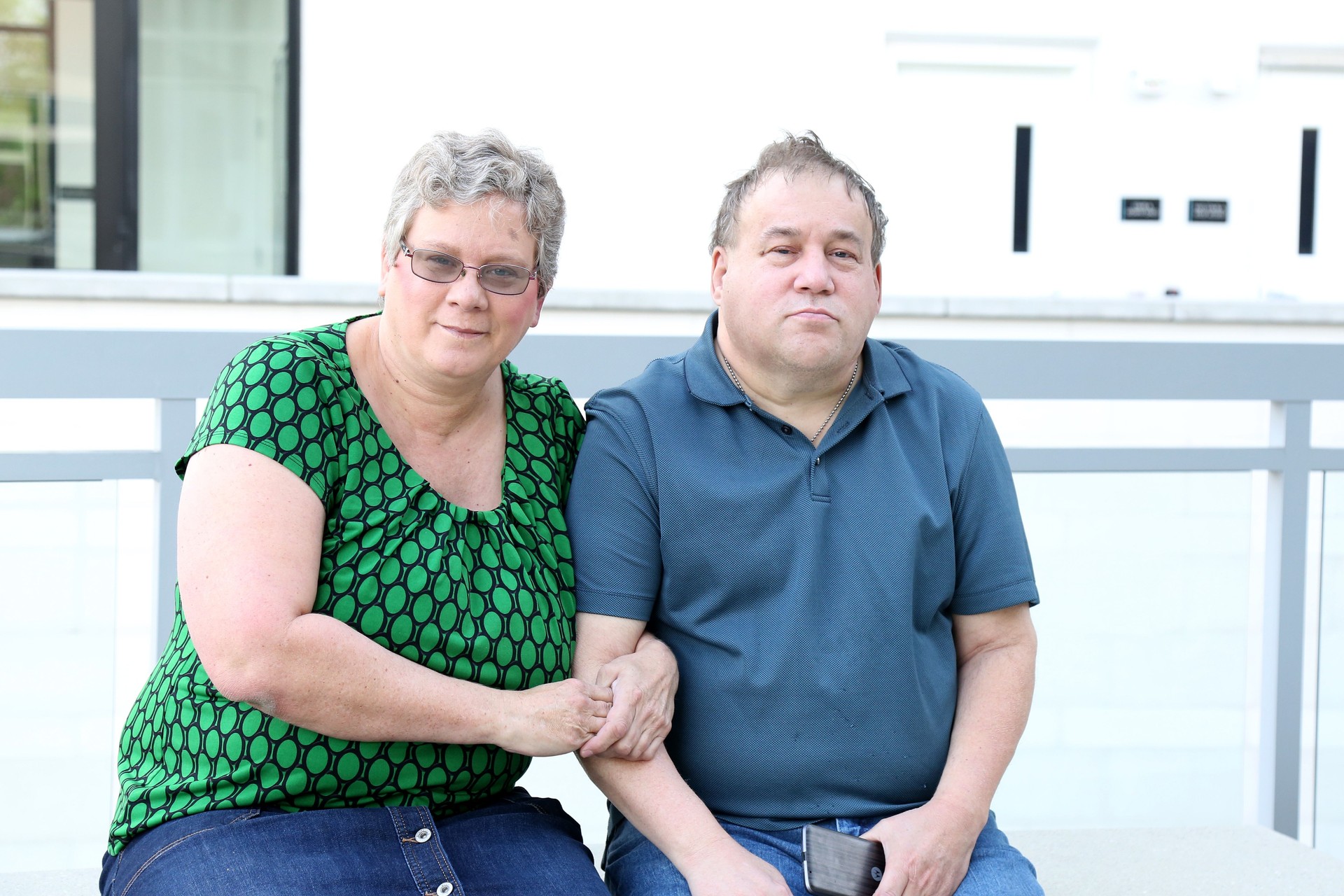 Mature adult female sits next to her Autistic brother