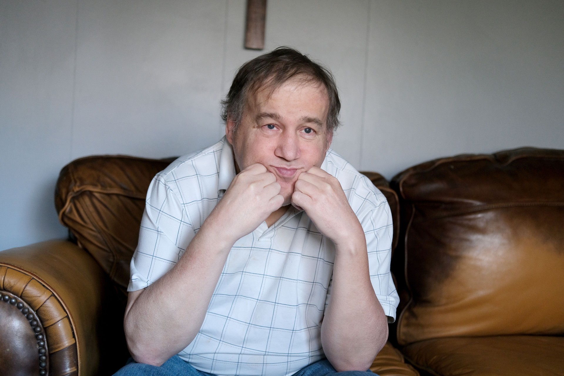  Adult autistic man with a worried expression—representing caregiver stress, unmet support needs, and the urgency of future planning for adults with autism and developmental disabilities