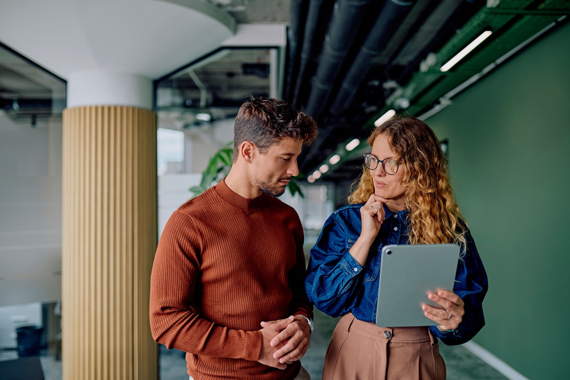 Business colleagues discussing project ideas using digital tablet