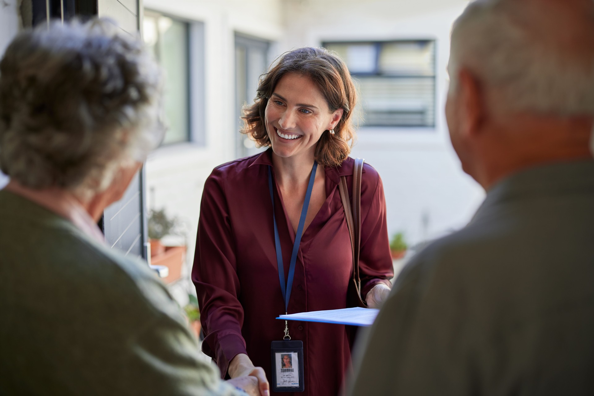 Social worker meeting elder couple during visit at home