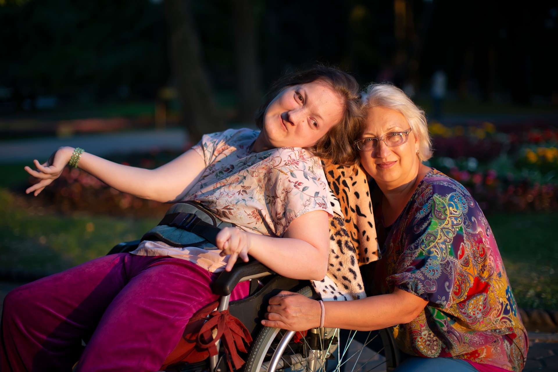 Well-groomed adult woman with disabilities in a wheelchair beside her sister—representing sibling guardianship, disability advocacy, and long-term planning for adults with developmental and physical disabilities